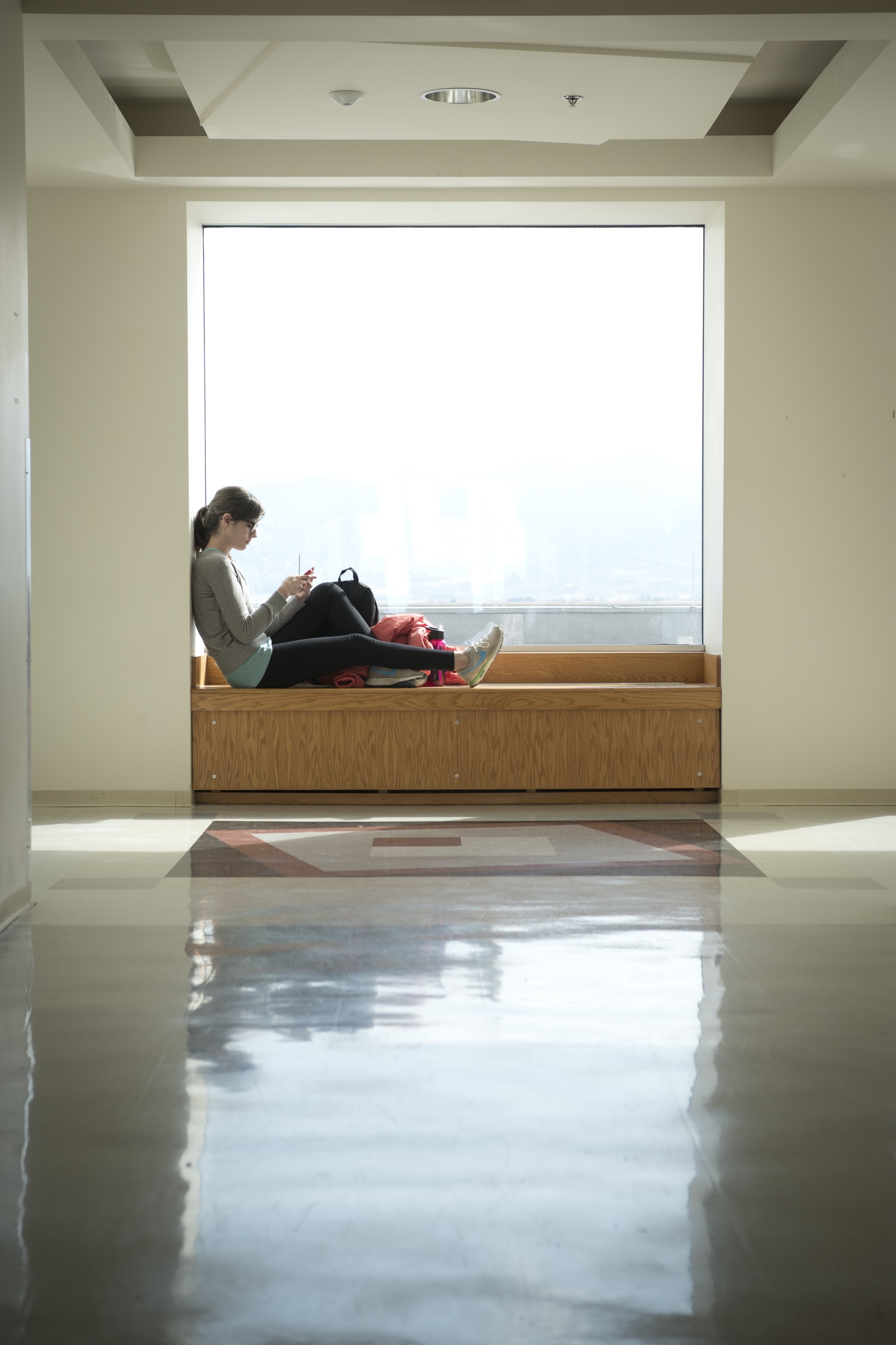 student relaxing in Columbine Hall window