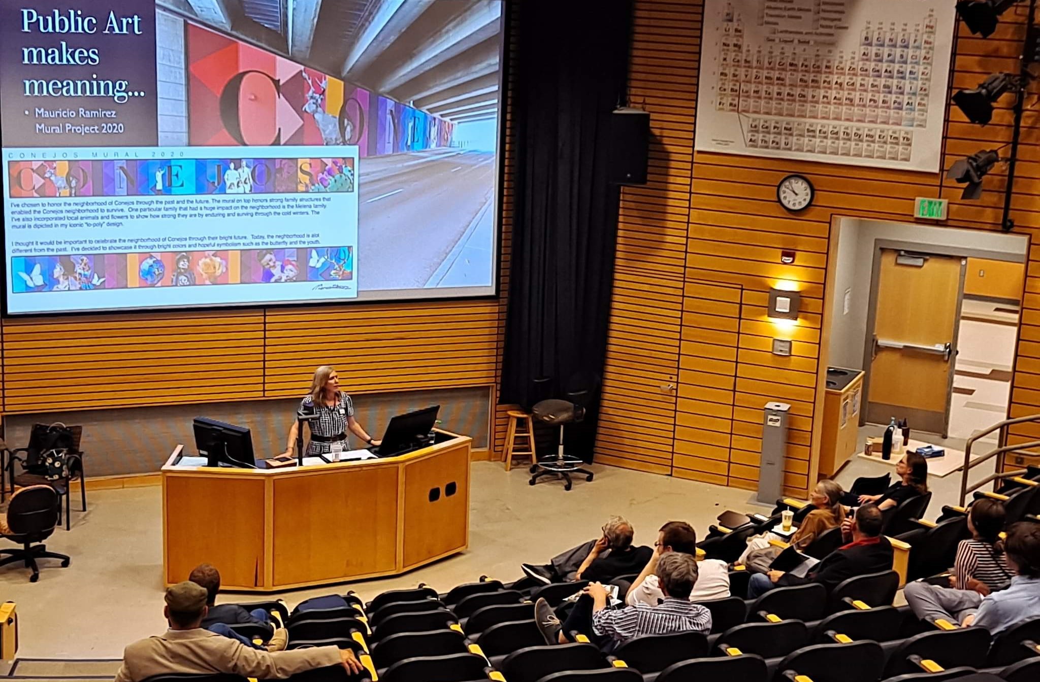 Person giving lecture to audience