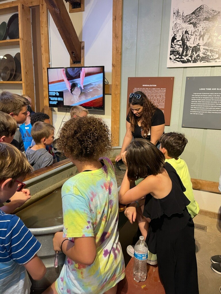 Museum display with intern and kids