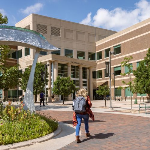 student walking into columbine hall on uccs campus